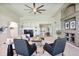 Cozy living room features neutral decor, fireplace, ceiling fan and open floorplan at 16283 Olive Way, Brighton, CO 80602