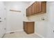 Mud room features a utility sink, coat hooks, tiled flooring and washer/dryer hook ups at 16283 Olive Way, Brighton, CO 80602