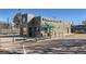 Coffee shop exterior with drive-thru, outdoor seating, and ample parking on a sunny day at 384 S Decatur St, Denver, CO 80219