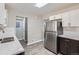 Updated kitchen featuring stainless steel refrigerator and dark cabinets at 384 S Decatur St, Denver, CO 80219