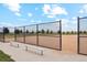 A fenced-in baseball field is visible, complete with benches, under a bright sky at 48220 Shetland Dr, Bennett, CO 80102