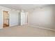 Spacious bedroom with neutral carpet, bathroom access and large closet at 48220 Shetland Dr, Bennett, CO 80102