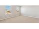 Bright bedroom with neutral carpet, two windows and large closet at 48220 Shetland Dr, Bennett, CO 80102