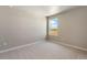 Bright bedroom with neutral carpet, and a window with a view at 48220 Shetland Dr, Bennett, CO 80102
