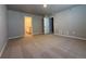 Carpeted bedroom with neutral walls, closet, and a doorway to the bathroom at 48220 Shetland Dr, Bennett, CO 80102