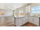 Open-concept kitchen featuring an island, wood laminate floors, hard surface counters, and adjacent living area at 48220 Shetland Dr, Bennett, CO 80102