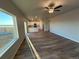 Spacious living room featuring hardwood floors and ample natural light from a large window at 48220 Shetland Dr, Bennett, CO 80102