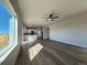 Spacious living room with luxury vinyl plank flooring, recessed lighting, and a large window at 48220 Shetland Dr, Bennett, CO 80102