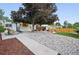 Backyard featuring a shed, lush rock garden, partial lawn, and wood deck with covered patio at 15034 E Floyd Ave, Aurora, CO 80014