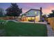 Spacious backyard featuring lush green lawn, patio area with outdoor dining, and well-maintained landscaping at 15034 E Floyd Ave, Aurora, CO 80014
