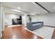 Finished basement featuring hardwood floors, recessed lighting, comfortable seating, and entertainment area at 15034 E Floyd Ave, Aurora, CO 80014