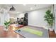 Finished basement with exercise area featuring hardwood floors and exercise mat at 15034 E Floyd Ave, Aurora, CO 80014