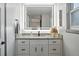 Bright bathroom featuring a modern vanity, granite countertop, and a large, illuminated mirror at 15034 E Floyd Ave, Aurora, CO 80014