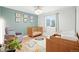 Cozy Bedroom with wooden crib, comfortable armchair, and soft, colorful rug at 15034 E Floyd Ave, Aurora, CO 80014