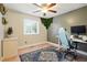 Bedroom with hardwood floors, a ceiling fan, and a modern, ergonomic workspace at 15034 E Floyd Ave, Aurora, CO 80014