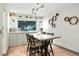 Cozy breakfast nook with a large window, built-in shelving, and stylish decor for delightful morning meals at 15034 E Floyd Ave, Aurora, CO 80014