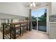 Eat-in dining area with sliding glass doors leading to a deck, offering an airy and bright space at 15034 E Floyd Ave, Aurora, CO 80014