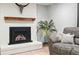 Living room fireplace with rustic wood mantel and decorative steer skull at 15034 E Floyd Ave, Aurora, CO 80014
