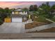 Charming two-story home with a well-manicured lawn, brick accents, a two car garage, and mature landscaping at 15034 E Floyd Ave, Aurora, CO 80014