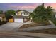 Charming two-story home with a well-manicured lawn, brick accents, a two car garage, and mature landscaping at 15034 E Floyd Ave, Aurora, CO 80014