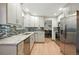 Modern kitchen features stainless steel appliances, granite countertops, and updated cabinetry and backsplash at 15034 E Floyd Ave, Aurora, CO 80014