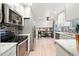 Well-lit kitchen features modern appliances, ample counter space, and a connected dining area at 15034 E Floyd Ave, Aurora, CO 80014