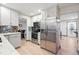 Updated kitchen boasts stainless steel appliances, granite countertops, and seamless flow to adjacent dining at 15034 E Floyd Ave, Aurora, CO 80014