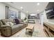 Spacious living room with comfortable seating, a large window and a view into the dining area at 15034 E Floyd Ave, Aurora, CO 80014