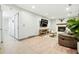 Open-concept living room with a fireplace, comfortable seating, and access to a laundry room at 15034 E Floyd Ave, Aurora, CO 80014