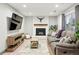 Cozy basement living room features a fireplace, plush sofa, and modern entertainment setup for relaxation at 15034 E Floyd Ave, Aurora, CO 80014