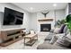 Cozy living room features a fireplace with a brick surround and a large sectional sofa at 15034 E Floyd Ave, Aurora, CO 80014