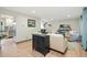 Open-concept living room featuring hardwood floors and neutral decor, seamlessly connecting to the kitchen at 15034 E Floyd Ave, Aurora, CO 80014