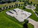 Aerial view of a skate park in a park with a series of ramps, rails, and concrete surfaces at 15034 E Floyd Ave, Aurora, CO 80014