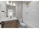 Well-lit bathroom with a tub and shower combo, plus ample countertop space at 5928 N Lisbon St, Aurora, CO 80019