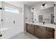 Modern bathroom with a double vanity, shower and tile flooring; dark fixtures and bright lighting at 5928 N Lisbon St, Aurora, CO 80019