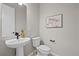 Stylish powder room with pedestal sink and decorative wall art at 5928 N Lisbon St, Aurora, CO 80019