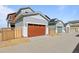 Row of garages showing wood-look doors and wood fences between the garages at 5928 N Lisbon St, Aurora, CO 80019