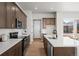 Kitchen featuring wood cabinets, stainless steel appliances, and an island with a sink at 5928 N Lisbon St, Aurora, CO 80019