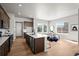 Open kitchen and dining area with stainless steel appliances, a central island, and natural light at 5928 N Lisbon St, Aurora, CO 80019