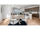 An open-concept living area with natural light, a modern kitchen, and a dining area at 5928 N Lisbon St, Aurora, CO 80019