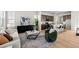 Open-concept living room flows into modern kitchen with stainless steel appliances and breakfast bar seating at 5928 N Lisbon St, Aurora, CO 80019
