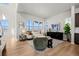 Bright living room featuring large windows, hardwood floors, and stylish decor; open to the modern kitchen at 5928 N Lisbon St, Aurora, CO 80019