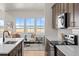 Modern kitchen and living room featuring stainless steel appliances and an abundance of natural light at 5928 N Lisbon St, Aurora, CO 80019