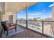 Inviting outdoor balcony with glass railings, showcasing stylish furniture, wood floors, and a picturesque urban view, ideal for relaxation at 888 N Logan St # 5A, Denver, CO 80203