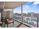 Inviting outdoor balcony with glass railings, showcasing stylish furniture, wood floors, and a picturesque urban view, ideal for relaxation at 888 N Logan St # 5A, Denver, CO 80203