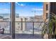 Balcony view shows city skyline, construction, and mountain backdrop at 888 N Logan St # 5A, Denver, CO 80203