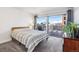 Bright bedroom features large windows, city views, and comfortable furnishings at 888 N Logan St # 5A, Denver, CO 80203