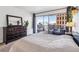 Bedroom featuring a walk out balcony and cityscape view in a modern apartment at 888 N Logan St # 5A, Denver, CO 80203