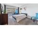 Well-lit bedroom with a comfortable bed, balcony access, and city views at 888 N Logan St # 5A, Denver, CO 80203