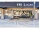 Front of 888 Logan building with glass doors and sidewalk at 888 N Logan St # 5A, Denver, CO 80203